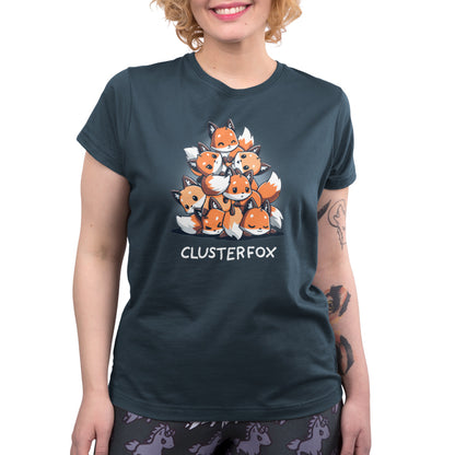 A person in a denim blue t-shirt with an illustration of multiple foxes stacked in a pyramid and the text "CLUSTERFOX" below, made from super soft ringspun cotton, Clusterfox by monsterdigital.
