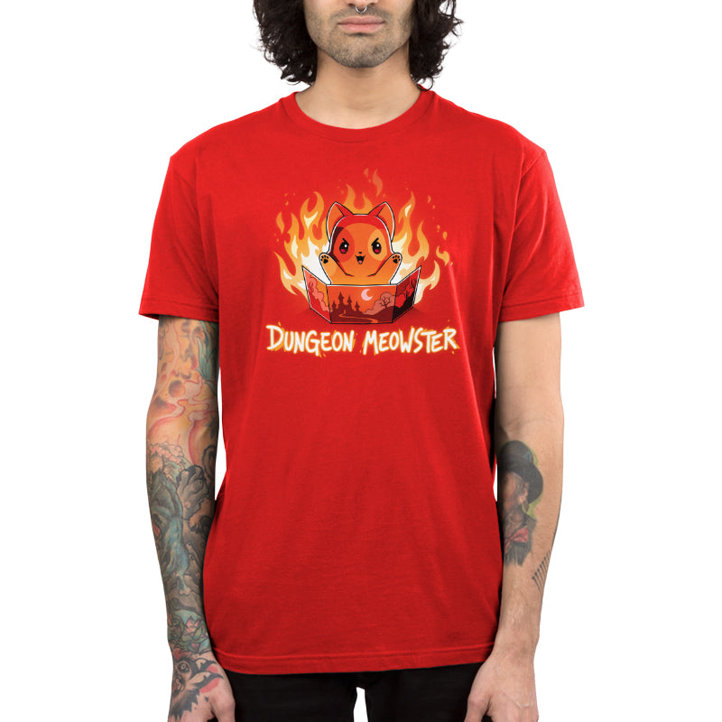 Premium Cotton T-shirt_TeeTurtle Dungeon Meowster garnet red t-shirt featuring a cartoon red cat surrounded by flames with an evil look on its face  holding a book that has a castle, moon and trees on the cover with Dungeon Meowster written underneath. 