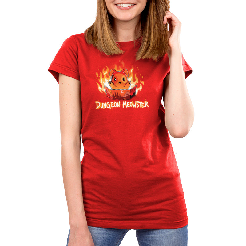 Premium Cotton T-shirt_TeeTurtle Dungeon Meowster garnet red t-shirt featuring a cartoon red cat surrounded by flames with an evil look on its face  holding a book that has a castle, moon and trees on the cover with Dungeon Meowster written underneath. 