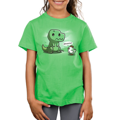 A child wearing a super soft ringspun cotton green t-shirt featuring a cartoon dinosaur and a small bird. The unisex tee captures a charming moment as the bird says "Grandpa?" to the dinosaur. This is the Family Reunion shirt by monsterdigital.