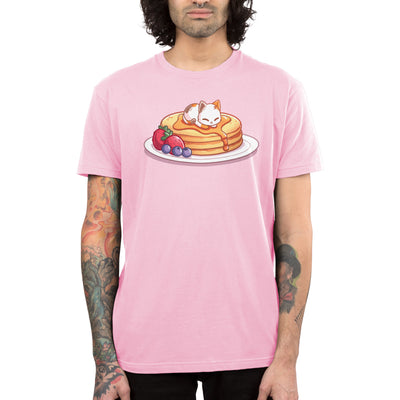 Premium Cotton T-shirt_TeeTurtle light pink Fluffy Pancakes apparel featuring a calico cat sleeping on top of a stack of syrupy pancakes with strawberries, and blueberries on the side.