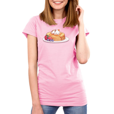 Premium Cotton T-shirt_TeeTurtle light pink Fluffy Pancakes apparel featuring a calico cat sleeping on top of a stack of syrupy pancakes with strawberries, and blueberries on the side.