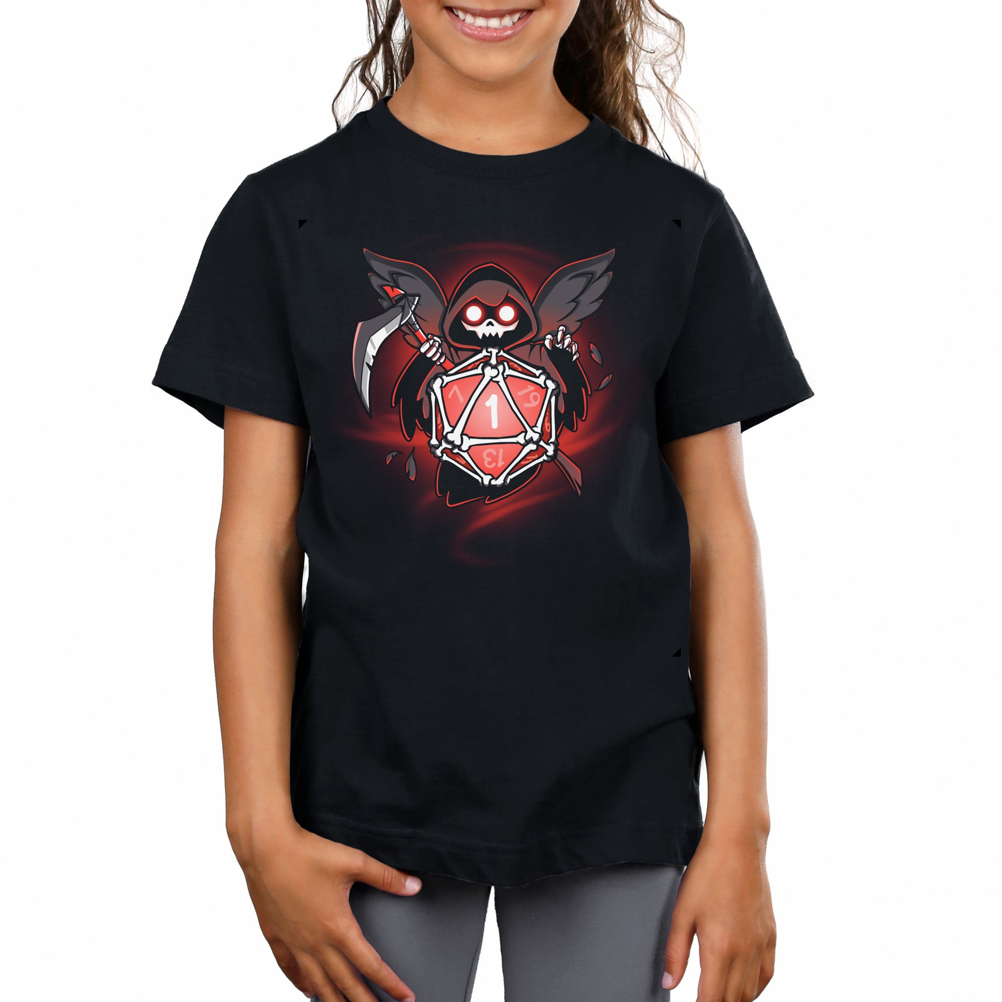 A young person is wearing a black T-shirt made of super soft ringspun cotton, featuring a geometric design titled "Grim Reaper's Roll" by monsterdigital, which depicts a reaper holding a gaming die marked with the number one ("critical fail").