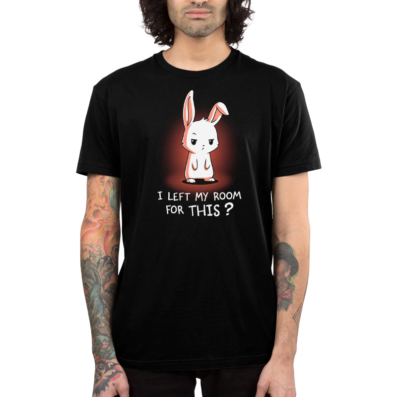 Person wearing a super soft cotton black T-shirt with a white rabbit illustration and the text "I Left My Room For This?" in white and red letters from monsterdigital.