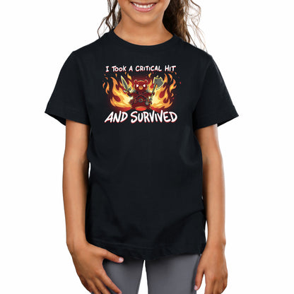 A child wearing a super soft ringspun cotton black t-shirt featuring a design of a red character holding swords surrounded by flames and text that reads, "I Took A Critical Hit and Survived" from monsterdigital.
