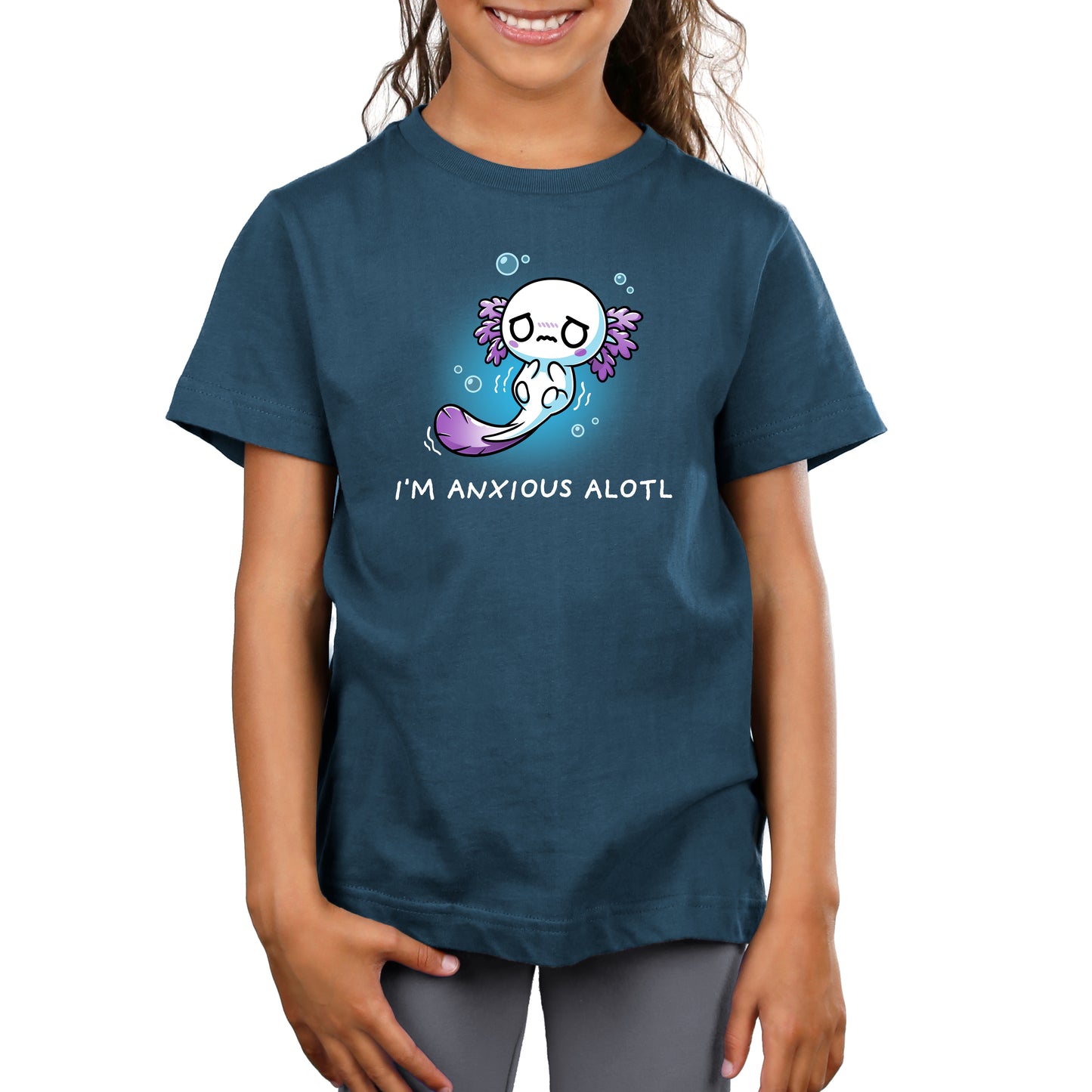 A smiling child wears a denim-colored t-shirt made from Super Soft Ringspun Cotton, featuring a cute axolotl illustration and the text "I'm Anxious Alotl" from monsterdigital.