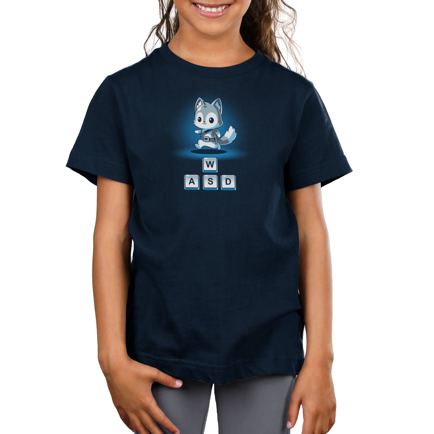 Young child wearing a navy blue T-shirt with a cartoon fox and the letters W, A, S, D printed on it, perfect for fans of PC games. The "Keys to Adventure" by monsterdigital is made from super soft ringspun cotton for ultimate comfort.
