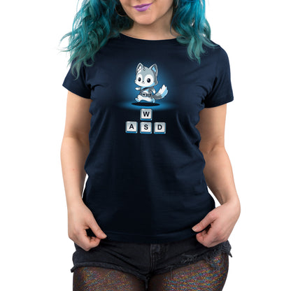 Person wearing a navy blue T-shirt made from super soft ringspun cotton, featuring a cartoon fox sitting on a laptop and standing on keyboard keys labeled W, A, S, and D. The person has blue hair and is wearing glittery black shorts, perfectly capturing the essence of PC games. They are sporting the "Keys to Adventure" T-shirt by monsterdigital.