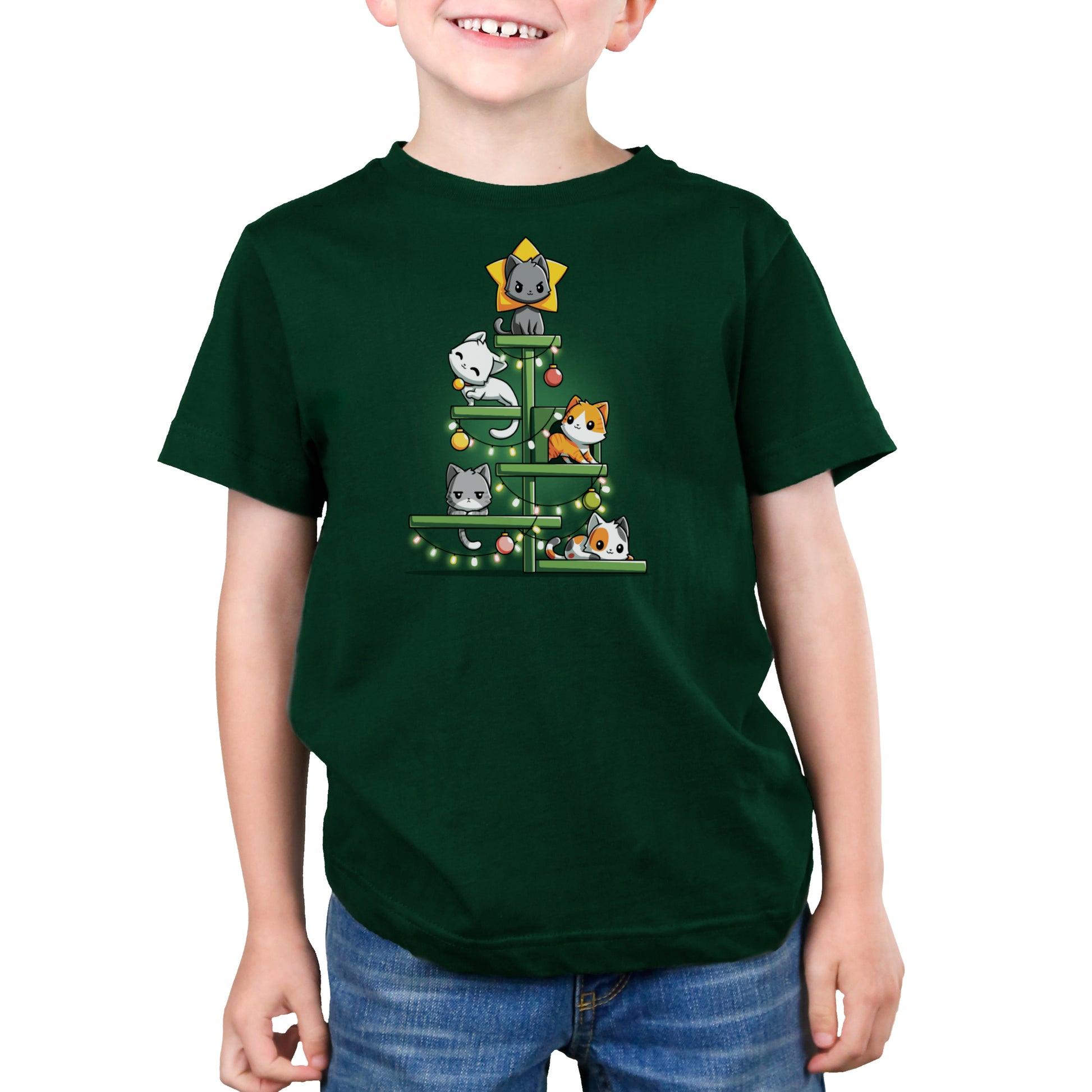 A child wearing a forest green Kitty Christmas Tree T-shirt by monsterdigital, with a Christmas tree made of cute cartoon cats, adorned with lights and ornaments. The shirt's super soft ringspun cotton looks cozy as the smiling child keeps their hands hidden.