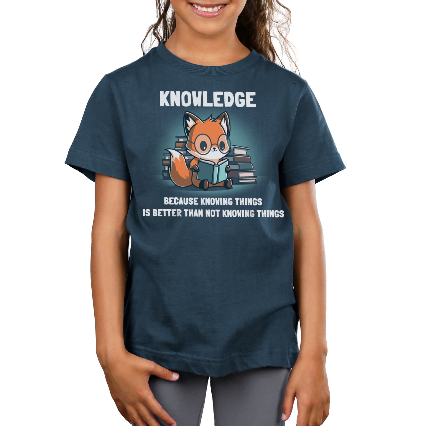 Premium Cotton T-shirt - A person wearing a super soft ringspun cotton, navy-blue Knowing Things apparel by monsterdigital featuring a cartoon fox reading books with the text: "Knowledge. Because knowing things is better than not knowing things.