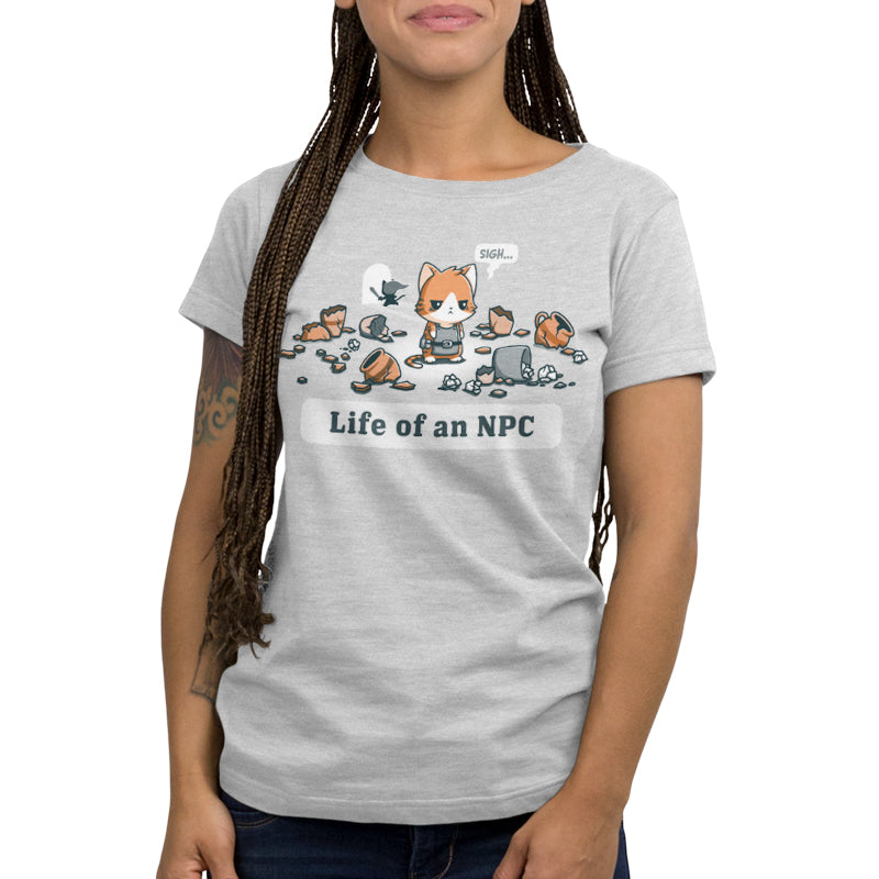 Person wearing a silver Life Of An NPC t-shirt from monsterdigital that features a cartoon fox surrounded by scattered items and the text "Life of an NPC," crafted from super soft ringspun cotton.