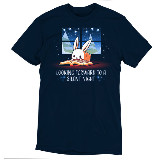A navy blue T-shirt featuring a cartoon rabbit reading a book by a window under a night sky, made from super soft ringspun cotton. It's accompanied by the text 