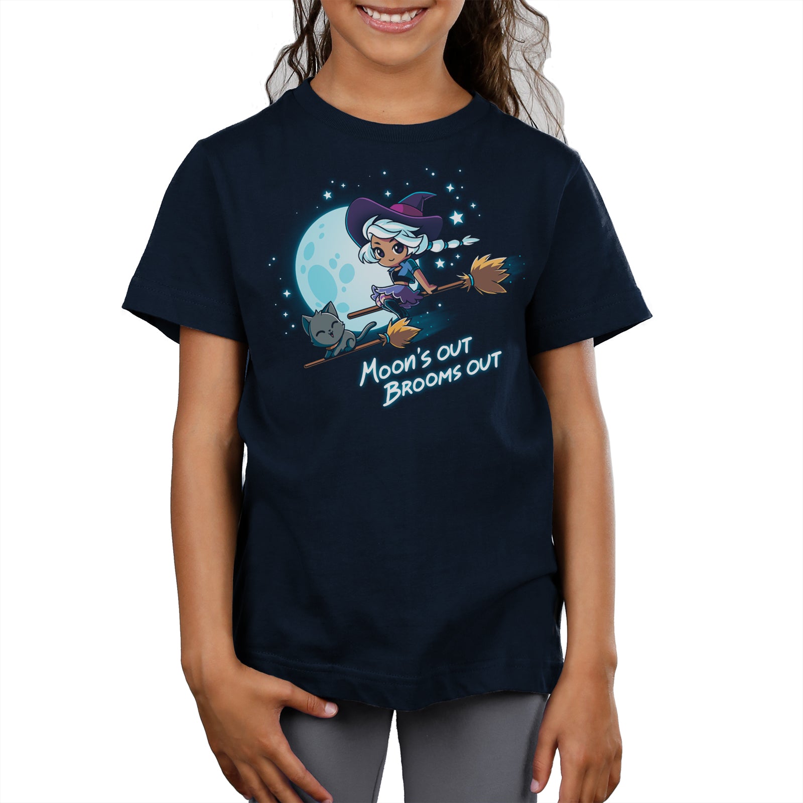 Premium Cotton T-shirt_TeeTurtle Moon's Out Brooms Out navy blue t-shirt featuring an illustration of a witch with light-gray hair, wearing a purple and dark-purple outfit and a dark purple witch's hat and a cartoon gray cat flying on two broom sticks past a full moon and starry sky. "Moon's OUT BROOMS OUT" is written underneath. 