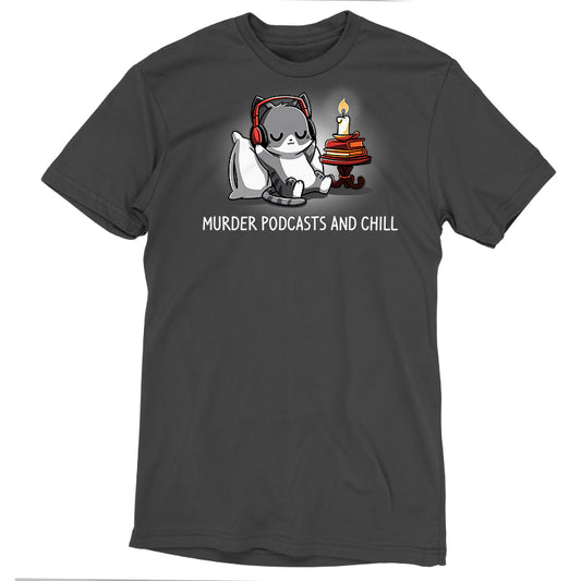 A super soft ringspun cotton, charcoal gray T-shirt featuring a relaxed cat wearing headphones and listening to a podcast, surrounded by a blanket, stack of books, cup of tea, and candle. The text reads 