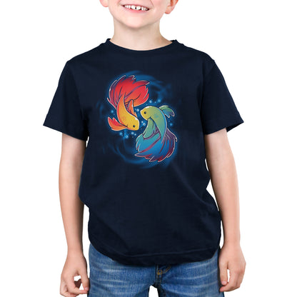 A child wearing a navy blue Monsterdigital Rainbow Betta t-shirt made of super soft ringspun cotton, featuring an illustration of two colorful, stylized Rainbow Betta fish facing each other.