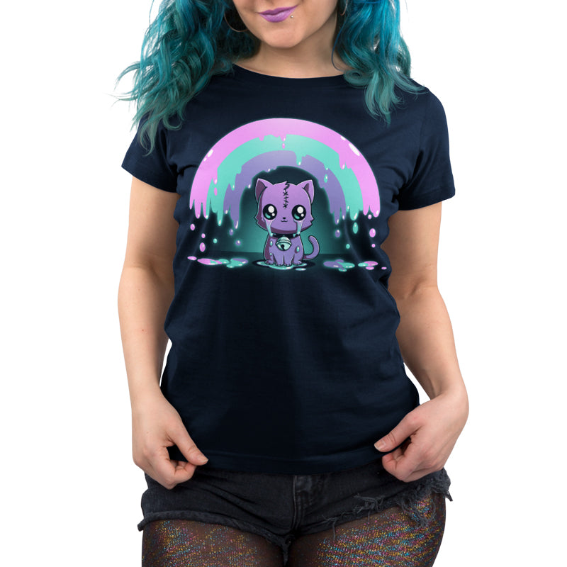 A person wearing a black monsterdigital Rainbow Crying Cat tee featuring a cartoon purple cat and a rainbow. The individual also has blue hair and sparkly shorts.