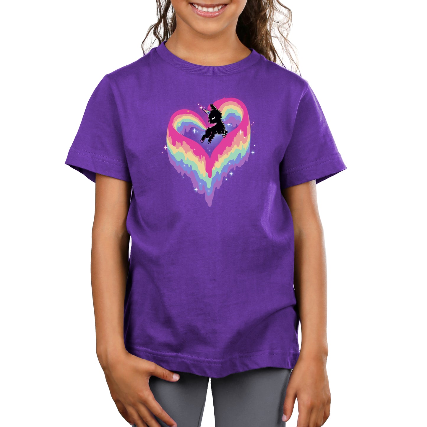 A young girl wearing a monsterdigital super soft ringspun cotton purple T-shirt adorned with a Rainbow Paint Unicorn.