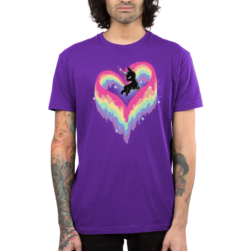 A man with long curly hair and tattooed arms is wearing a super soft ringspun cotton purple T-shirt featuring the monsterdigital Rainbow Paint Unicorn.