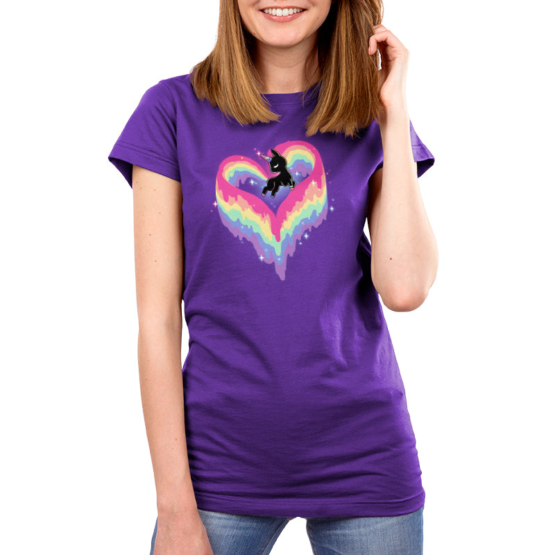 Woman wearing a super soft ringspun cotton purple t-shirt with a colorful heart design featuring the Rainbow Paint Unicorn by monsterdigital.