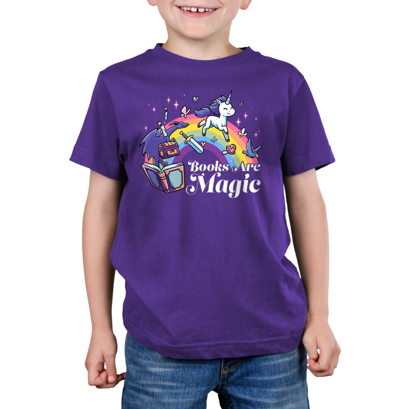 A child wearing a super soft ringspun cotton unicorn T-shirt featuring books and a rainbow with the text "Books Are Magic" by monsterdigital.