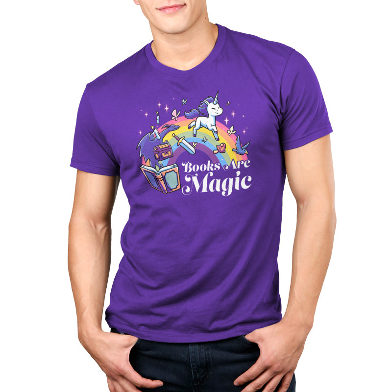 A person wearing a super soft ringspun cotton T-shirt adorned with a unicorn, books, and birds. The text "Books Are Magic" by monsterdigital is proudly displayed.