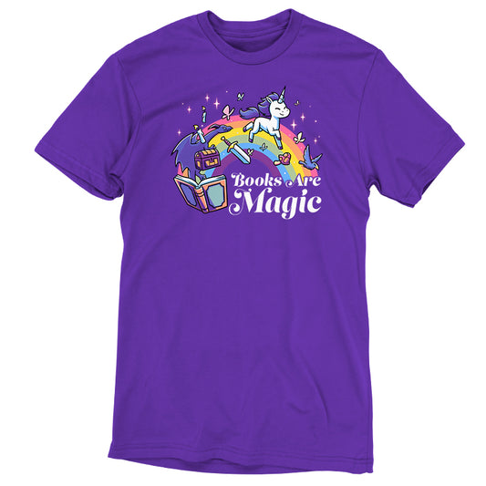 The **Books Are Magic** by **monsterdigital** is a purple unicorn T-shirt made of super soft ringspun cotton, featuring an illustration of a unicorn and a rainbow above books, with the text 
