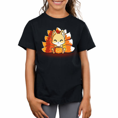 A young girl is beaming while wearing a black monsterdigital original t-shirt featuring a Candy Corn Kitsune holding a pumpkin. Her long, wavy hair cascades beautifully, complementing the super soft ringspun cotton of her adorable outfit.