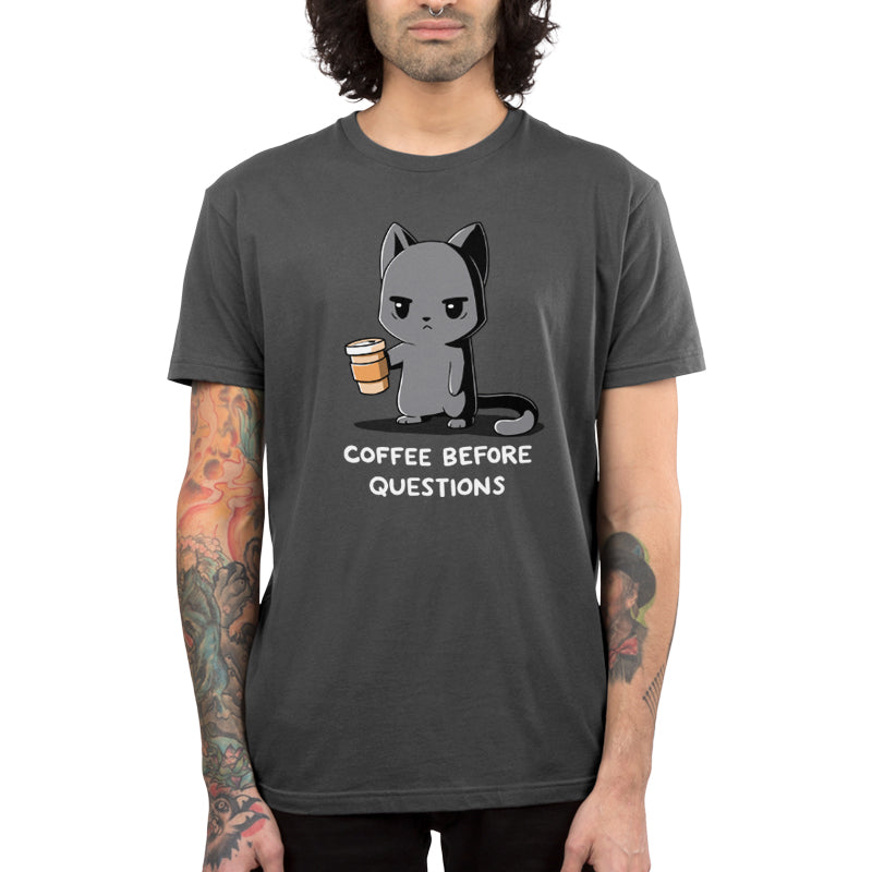 Premium Cotton T-shirt_TeeTurtle charcoal gray Coffee Before Questions. Featuring a grumpy cat holding a coffee cup saying, "Coffee Before Questions".