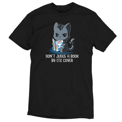 Premium Cotton T-shirt_TeeTurtle black Don't Judge a Book By It's Cover featuring seemingly grumpy, goth-looking cat wearing a spiked collar and spiked ring on its tail reading a bright, happy-looking rainbow-covered book above the text 'Don't Judge A Book By Its Cover'.