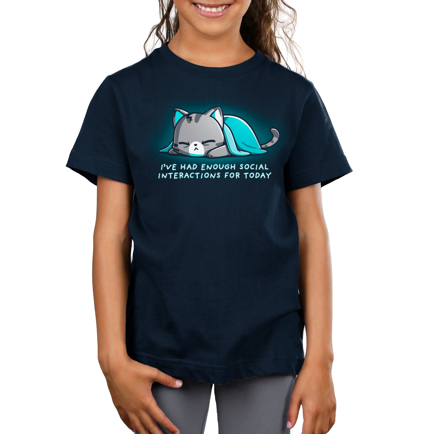 A child wearing a navy blue T-shirt, made of super soft ringspun cotton, with a graphic of a sleeping cat and the text "Enough Social Interactions" from monsterdigital.