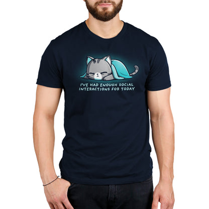 A person wears a super soft ringspun cotton navy blue t-shirt featuring an illustration of a sleeping cat under a blanket and the text “I’ve had enough social interactions for today.” This unisex tee, the Enough Social Interactions by monsterdigital, combines comfort with a relatable touch.