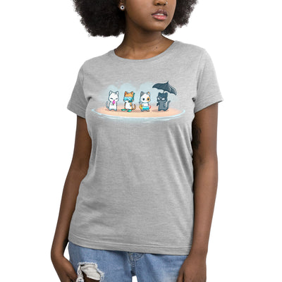 Premium Cotton T-shirt_TeeTurtle silver gray Fun In The Sun apparel featuring a white cat eating a popsicle, an orange tabby with diving goggles, a calico cat wearing a floater, and a black cat with sunglasses holding a frilly black umbrella all standing on a beach.