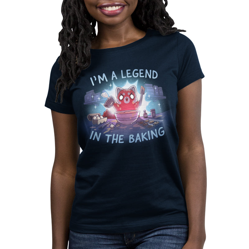 Premium Cotton T-shirt_TeeTurtle navy blue I'm a Legend in the Baking apparel featuring a red panda with lit up eyes holding a spatula and hand mixer in a kitchen surrounded by baking equipment, such as a sheet of cookies, eggs, and flour.