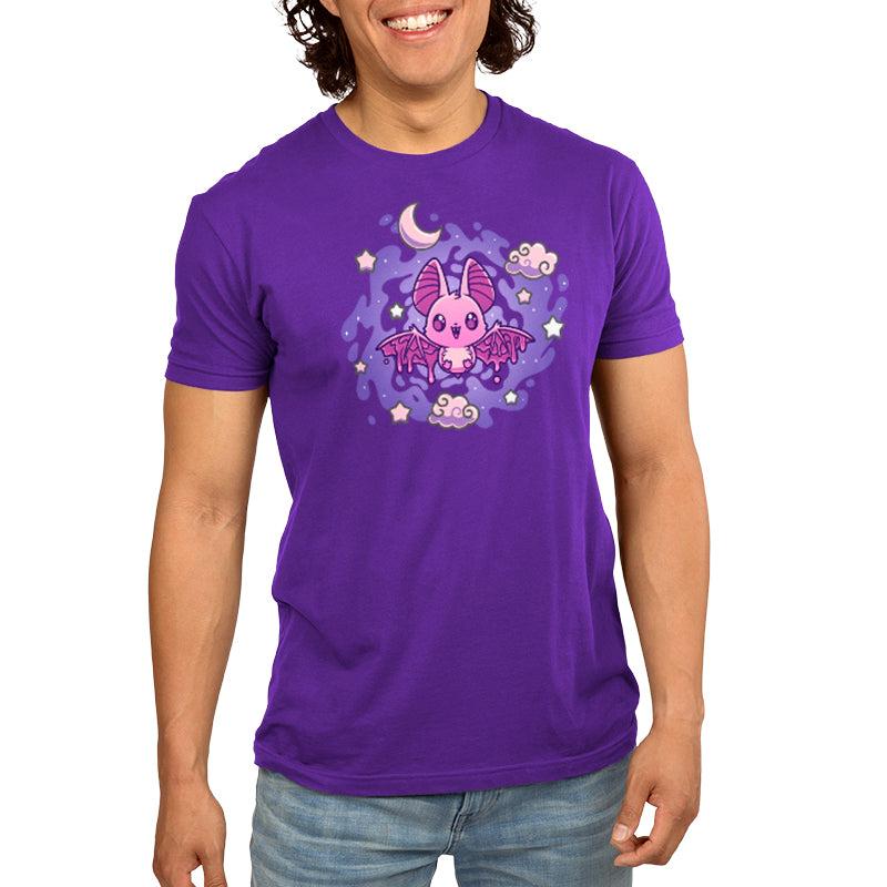 A woman wearing a purple monsterdigital Itty Bitty Bat Women's T-shirt adorned with a cute pink bat, moon, and stars design on the front.