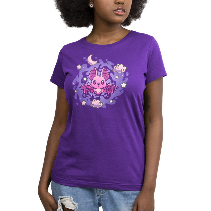 A person wearing a purple kids' T-shirt with an Itty Bitty Bat design on the front from monsterdigital. They are also sporting ripped blue jeans.