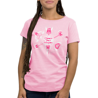 Premium Cotton T-shirt_TeeTurtle light pink Magical Weaponry apparel featuring a D20 with various magical weapons at the intersecting points with the caption, "Choose Your Weapon" in the center.