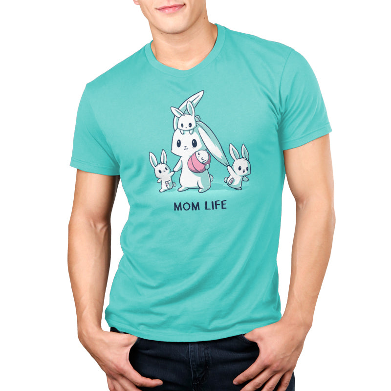A person wearing a Caribbean Blue monsterdigital T-shirt with a graphic of a mother bunny and three baby bunnies, and the text "MOM LIFE" below the illustration.