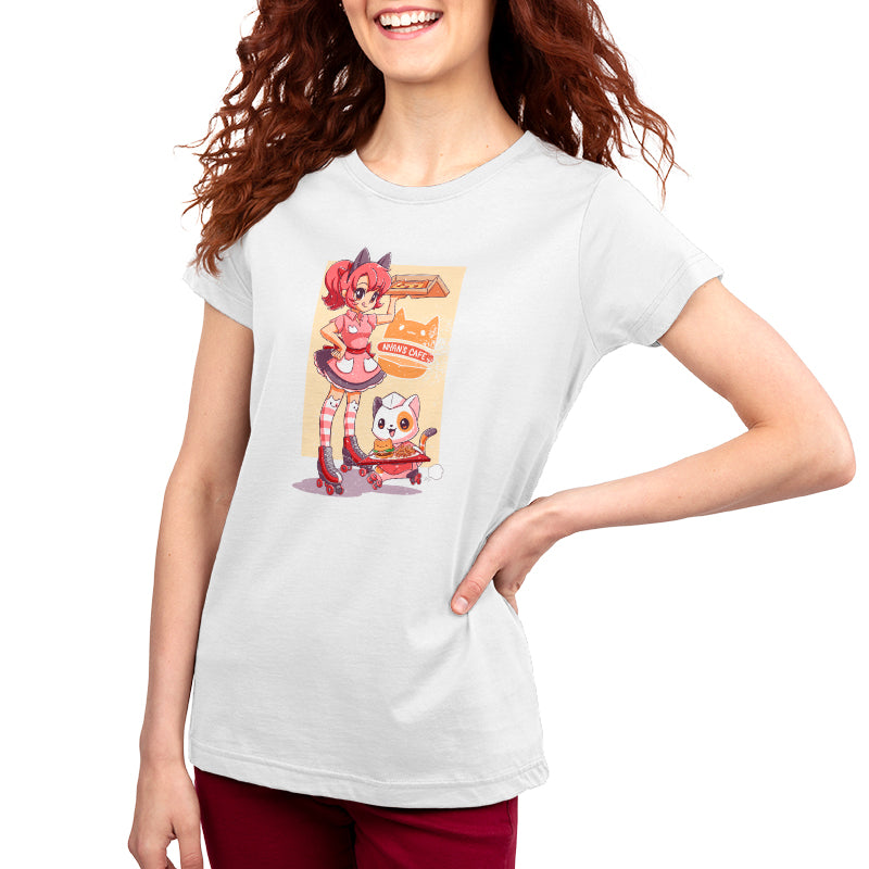 A woman stands against a white background, wearing a white women's t-shirt with a Nyan’s Cafe cartoon character design by monsterdigital. She has one hand on her hip and is smiling warmly.