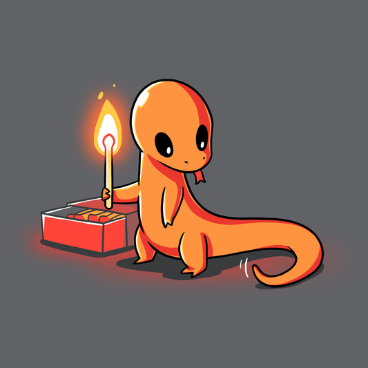 A small, orange cartoon lizard is holding a lit matchstick while standing next to a red box of matches on the super soft ringspun cotton of this charcoal gray tee from monsterdigital's Playing With Fire collection.