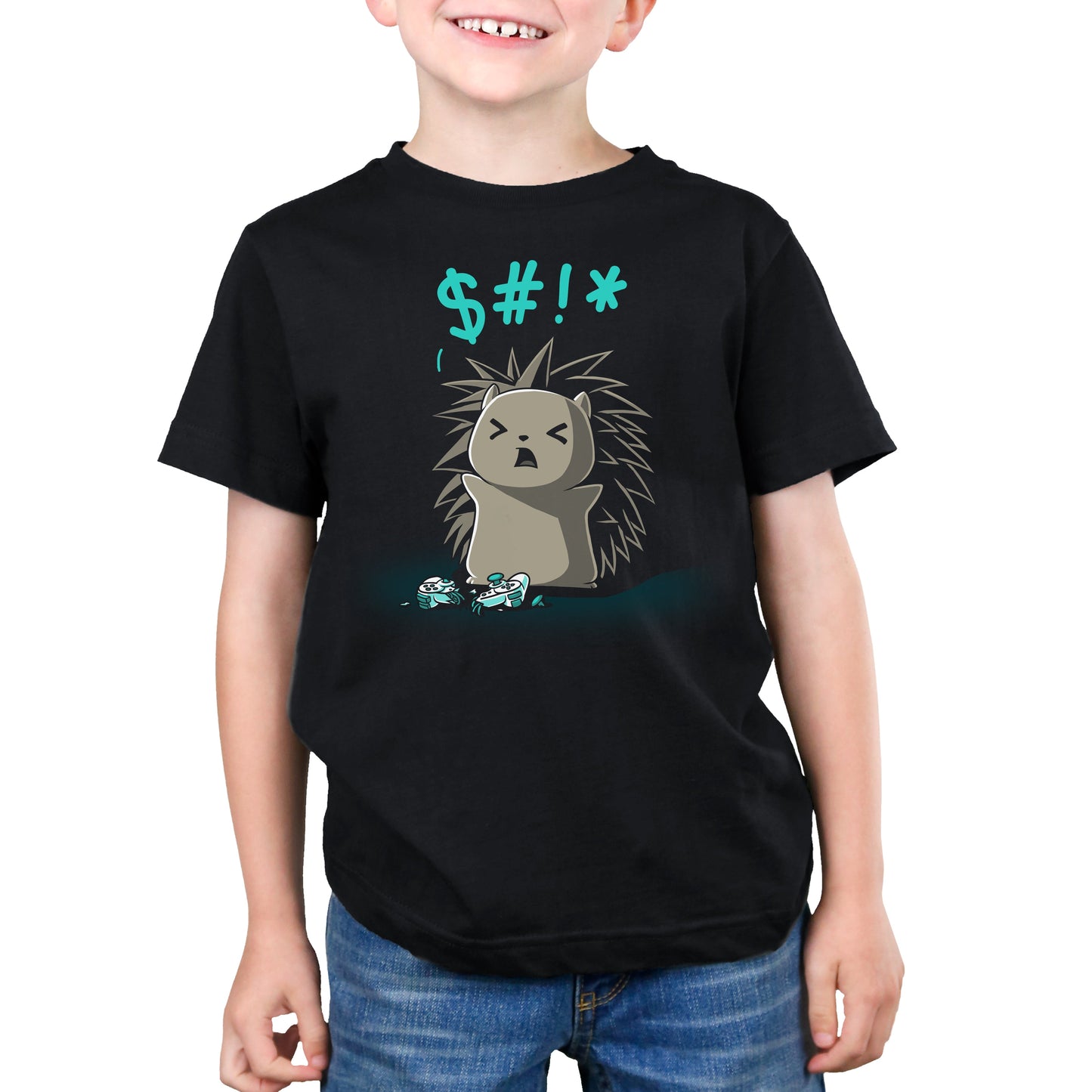 A child wearing a black Ragequit t-shirt from monsterdigital made from super soft ringspun cotton features an illustration of an angry cartoon hedgehog saying "$#!*". The child is smiling with their hands at their sides, standing near a broken object.