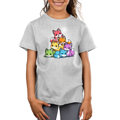 A child wearing the Rainbow Foxes super soft ringspun cotton T-shirt by monsterdigital, featuring an illustration of colorful cartoon foxes stacked in a pyramid formation.