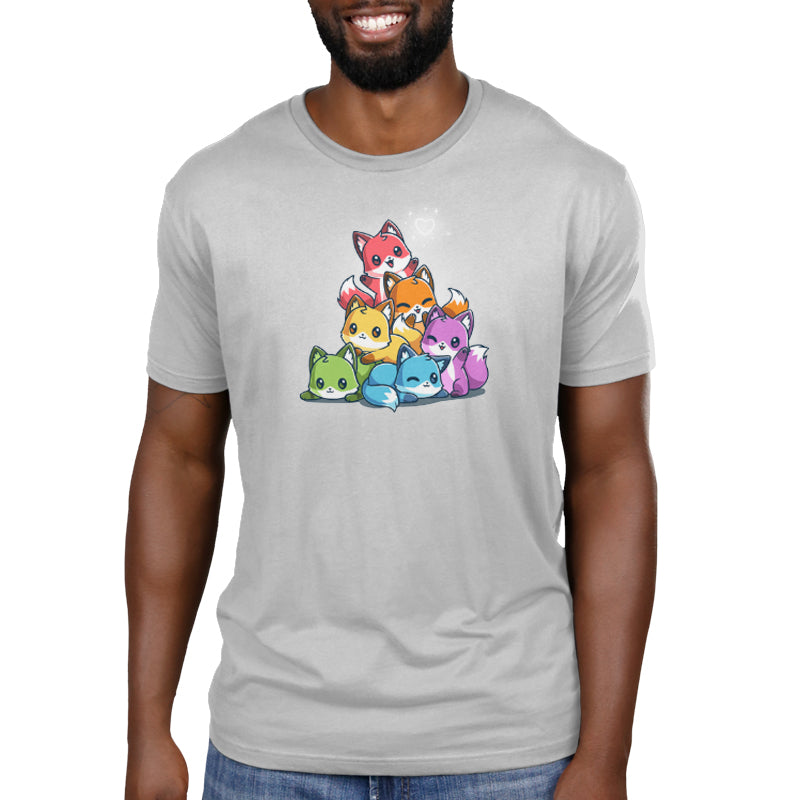 Man wearing a light gray, super soft ringspun cotton T-shirt featuring a design of six colorful cartoon cat characters stacked in a pyramid. The T-shirt is the Rainbow Foxes by monsterdigital.