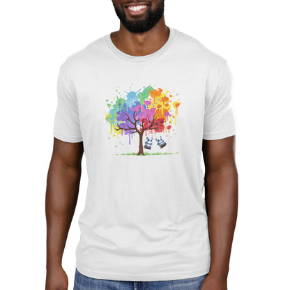 A person wearing a white Rainbow Panda Pals Men's T-shirt with a colorful tree graphic and a swing hanging from one of its branches by monsterdigital.