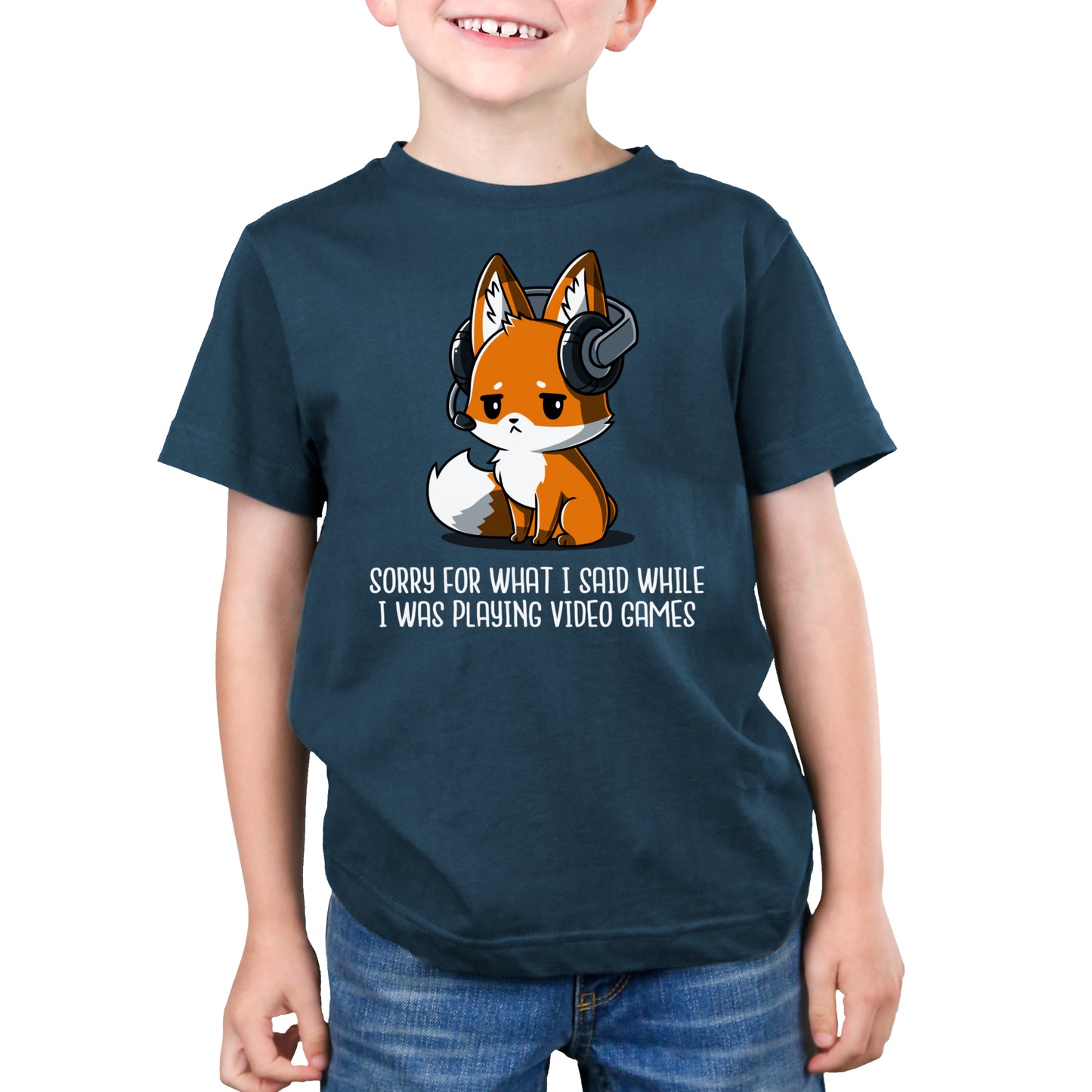 Premium Cotton T-shirt - A young person wearing a denim blue monsterdigital apparel featuring an illustration of a fox with headphones. The super soft ringspun cotton apparel reads, "Sorry For What I Said While I Was Playing Video Games.