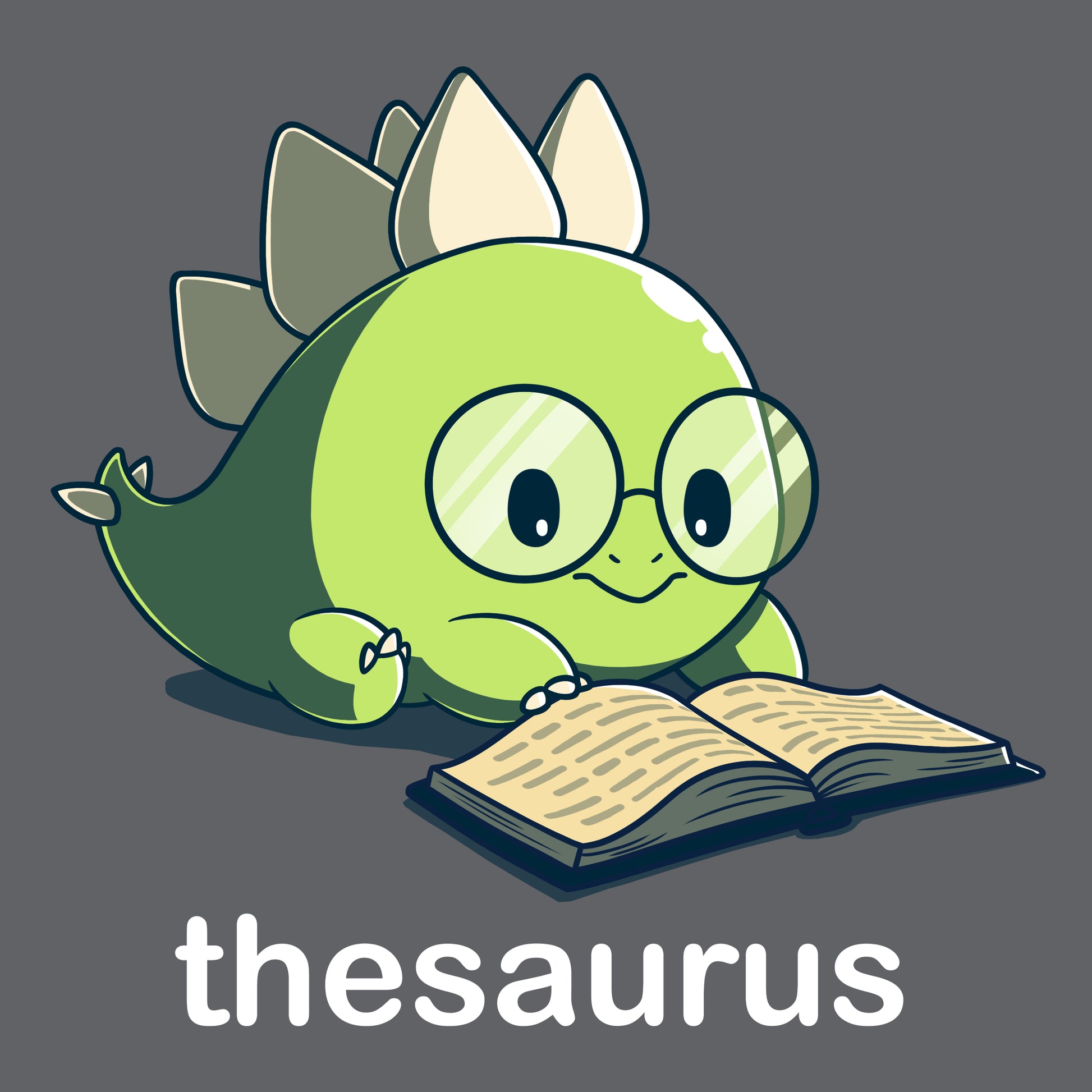 Premium Cotton T-shirt - A cute green dinosaur with glasses reads an open book on a Charcoal Gray apparel. Below it, the word "thesaurus" is written. The Thesaurus by monsterdigital is adorable!