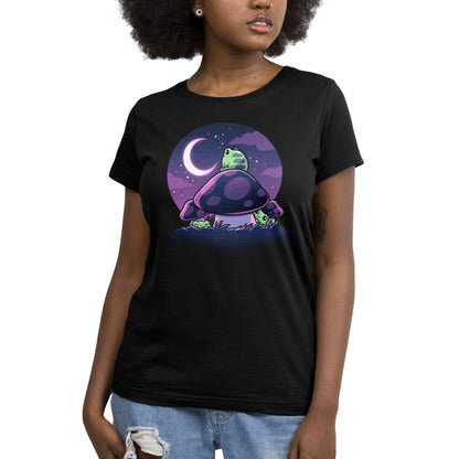 Premium Cotton T-shirt_TeeTurtle Twilight Toadstools black t-shirt featuring an illustration of a green frog sitting on top of a mushroom gazing up at the stars and a crescent moon in a violet-purple sky. There are two more green frogs underneath the mushroom cap, and two additional mushrooms on the side.