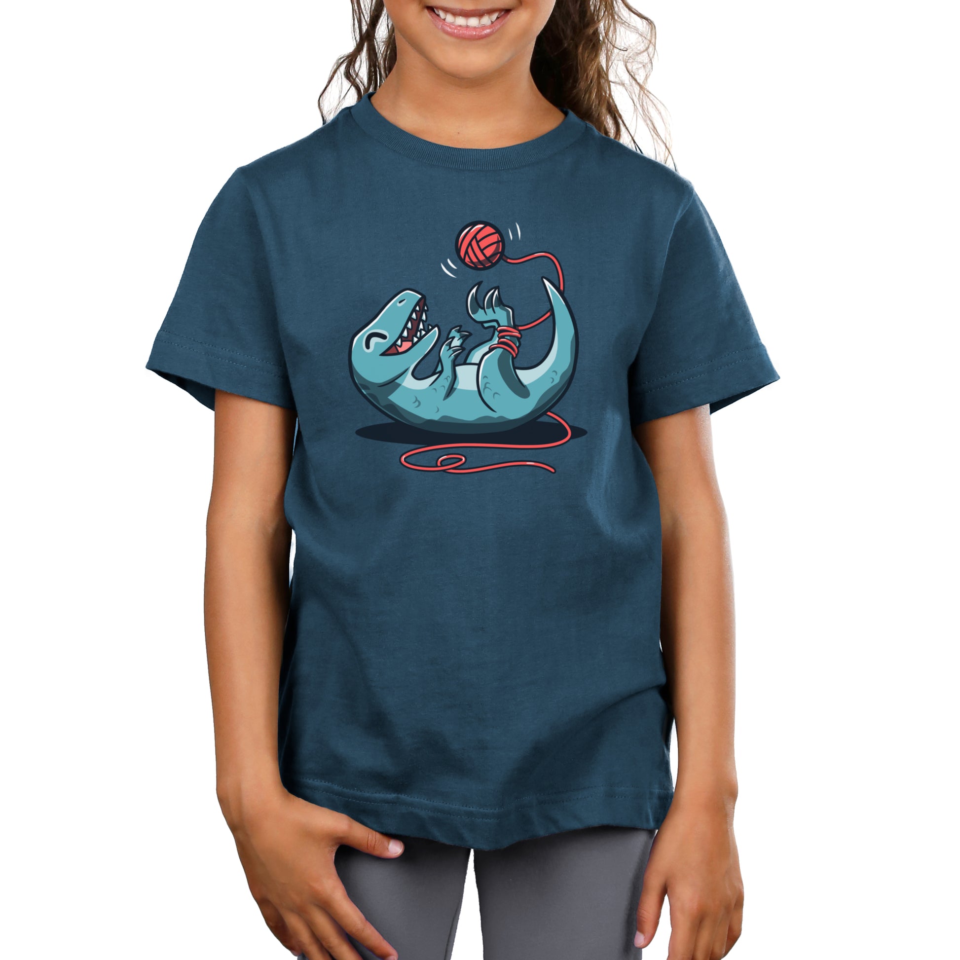 Premium Cotton T-shirt_TeeTurtle Velocikitty Denim t-shirt featuring an illustration of a velociraptor laying on its back, entangled in red yarn, playing happily with a ball of yarn above it in the air.