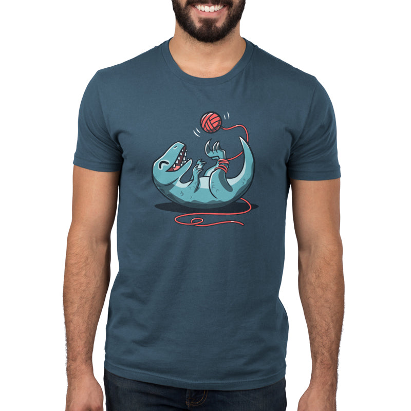 Premium Cotton T-shirt_TeeTurtle Velocikitty Denim t-shirt featuring an illustration of a velociraptor laying on its back, entangled in red yarn, playing happily with a ball of yarn above it in the air.