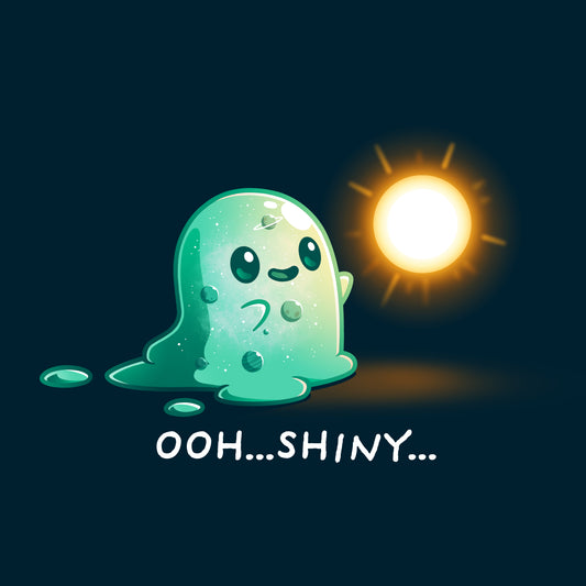 Illustration of a cute, green, translucent slime creature staring in awe at a glowing, golden orb on a Navy Blue T-shirt featuring the Shiny Distraction by monsterdigital, with the text 