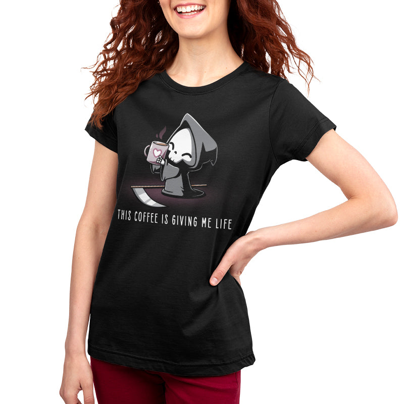 Premium Cotton T-shirt - A person with long, curly hair wearing a black apparel made from super soft ringspun cotton, featuring a cartoon grim reaper holding a coffee cup and the text "This Coffee Is Giving Me Life" by monsterdigital.